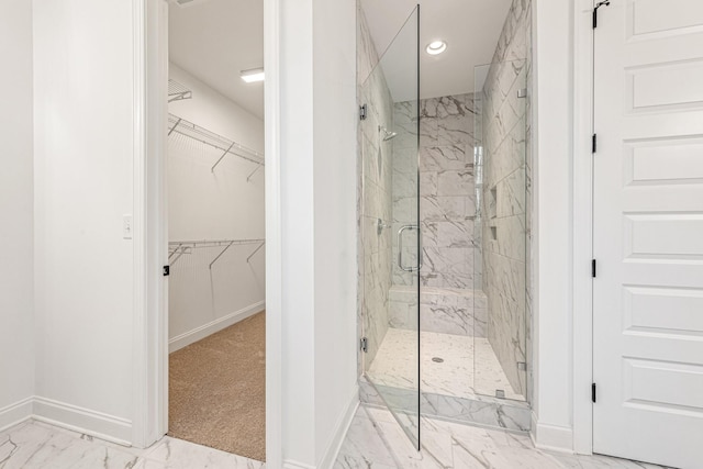 bathroom with a shower with door and tile floors