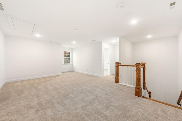 unfurnished room featuring light carpet