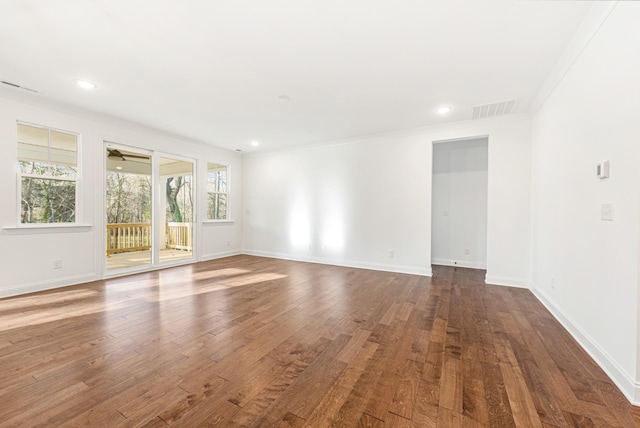 unfurnished room featuring crown molding and dark hardwood / wood-style floors