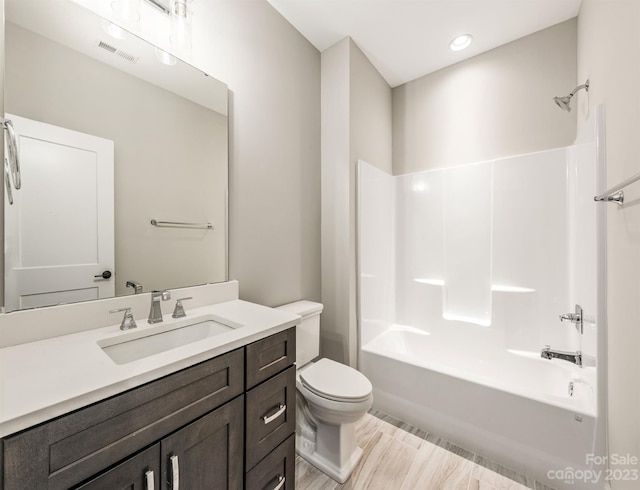 full bathroom featuring toilet, oversized vanity, and washtub / shower combination