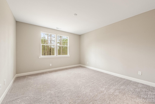 spare room with light carpet