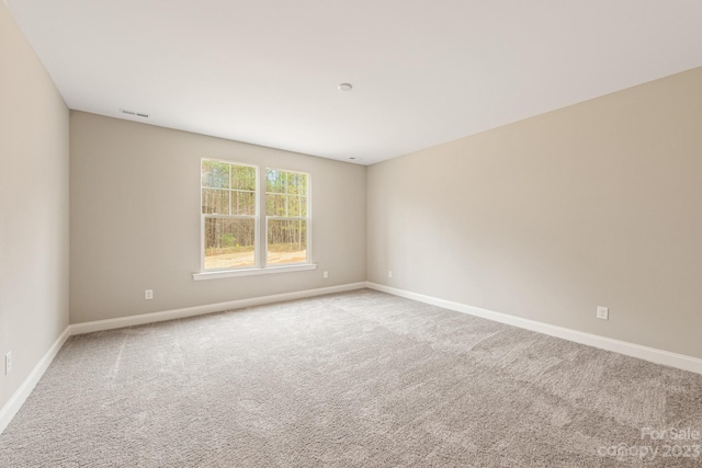 spare room with light carpet