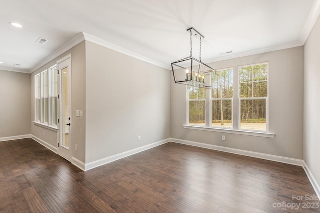 unfurnished room featuring ornamental molding, a wealth of natural light, dark wood-type flooring, and a chandelier