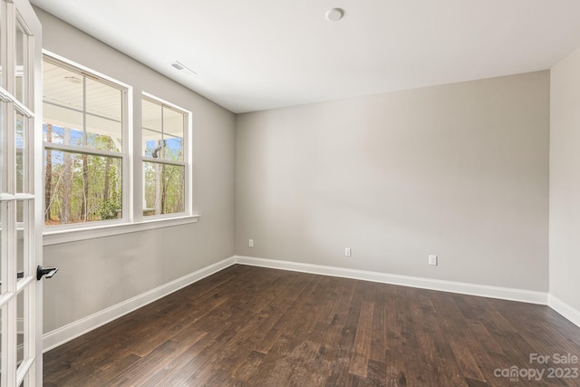 empty room featuring dark wood-type flooring