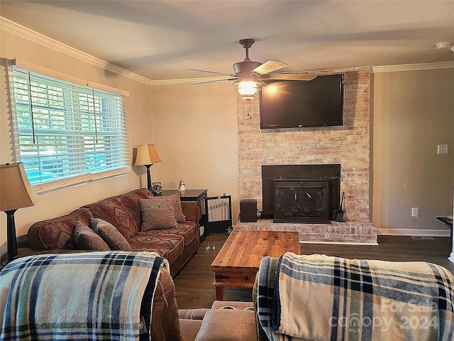 living room with ceiling fan, ornamental molding, a brick fireplace, and dark hardwood / wood-style flooring