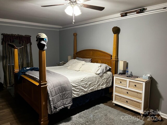 bedroom featuring dark wood-type flooring, ceiling fan, and crown molding