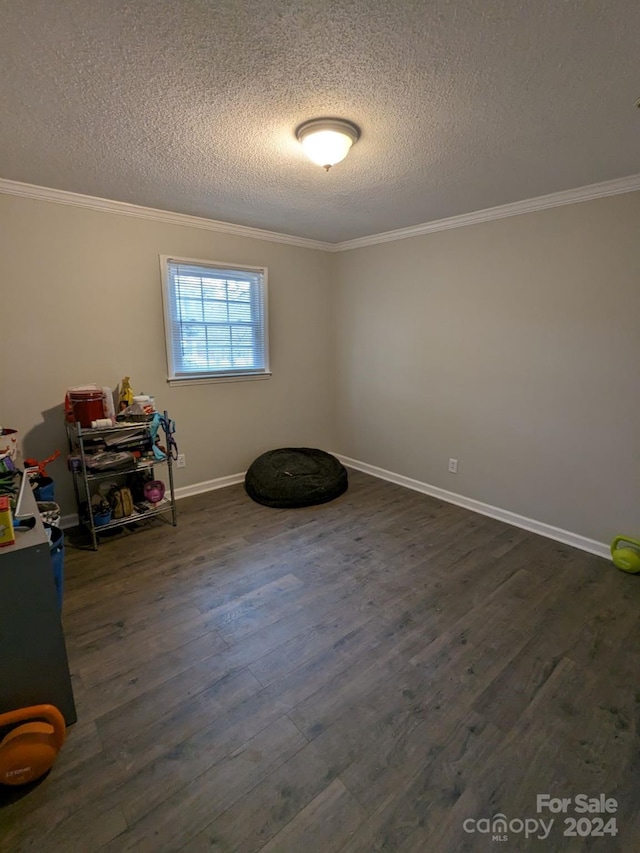 misc room with dark wood-type flooring, a textured ceiling, and crown molding