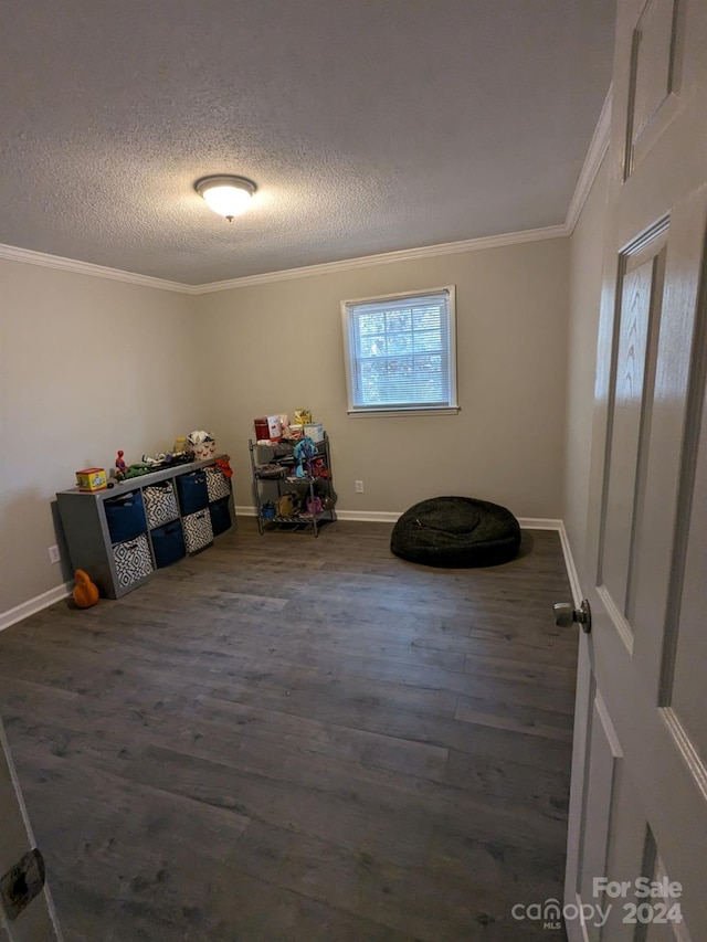 interior space featuring ornamental molding, dark hardwood / wood-style flooring, and a textured ceiling