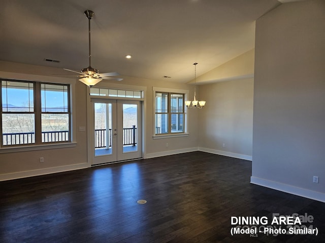 spare room featuring ceiling fan with notable chandelier, french doors, dark hardwood / wood-style floors, and vaulted ceiling