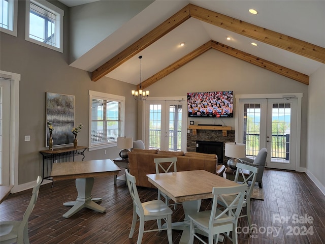 dining space featuring a fireplace, high vaulted ceiling, dark wood-type flooring, and french doors