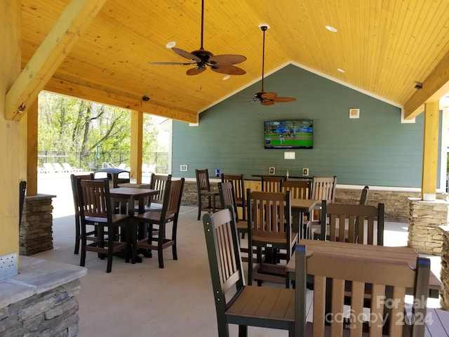 dining area featuring wood ceiling, high vaulted ceiling, and ceiling fan