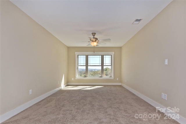 unfurnished room with ceiling fan and light colored carpet