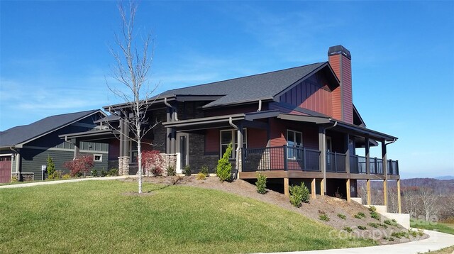 view of front of home with a porch and a front lawn