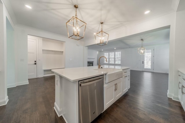 kitchen featuring dark wood-type flooring, stainless steel dishwasher, a kitchen island with sink, and pendant lighting