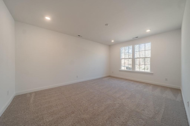 unfurnished room with light colored carpet