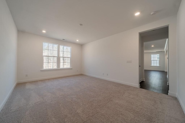 unfurnished room featuring dark carpet