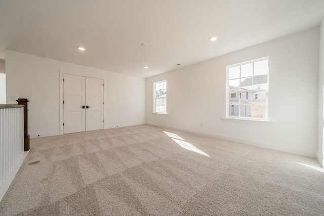 unfurnished room with light colored carpet