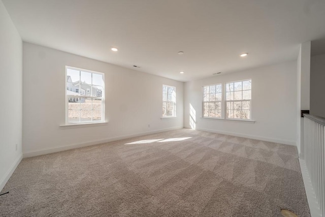 carpeted empty room featuring a healthy amount of sunlight