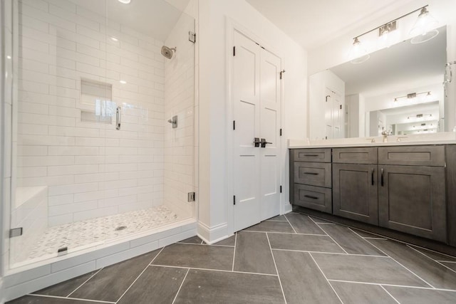 bathroom featuring vanity, tile floors, and a tile shower