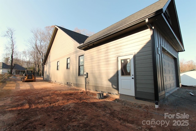 view of side of property with a garage