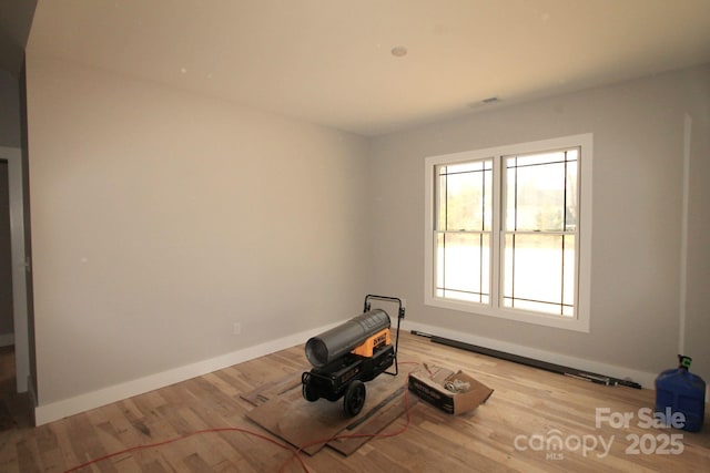 exercise room featuring light hardwood / wood-style flooring