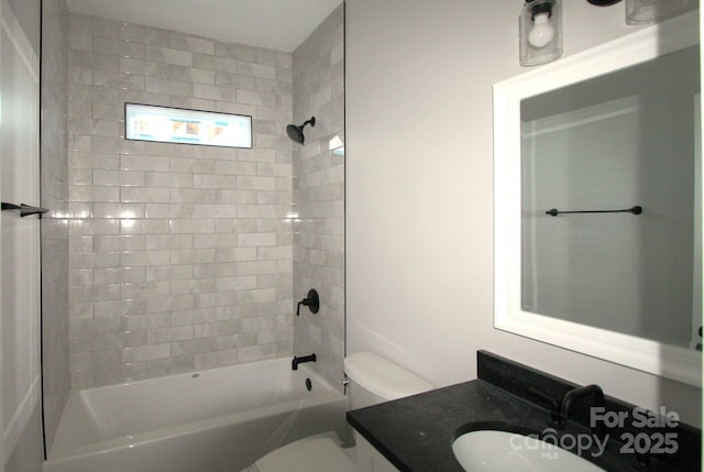 full bathroom featuring toilet, tiled shower / bath combo, and vanity