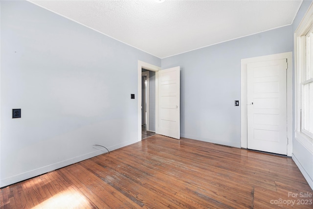 spare room with dark hardwood / wood-style flooring