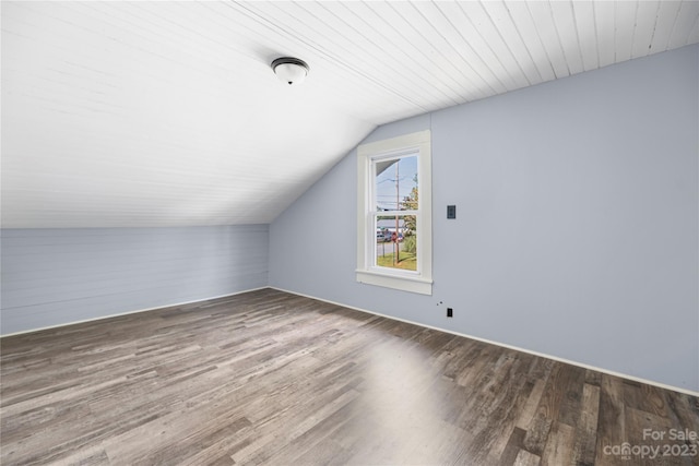 bonus room featuring dark hardwood / wood-style flooring and vaulted ceiling