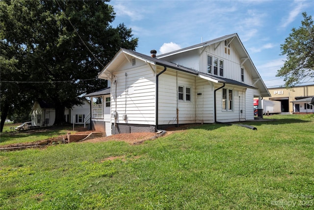 back of property with a lawn