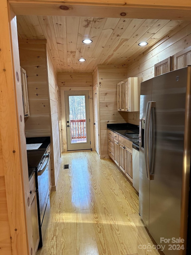 kitchen featuring appliances with stainless steel finishes, light hardwood / wood-style flooring, wooden ceiling, wood walls, and light brown cabinets