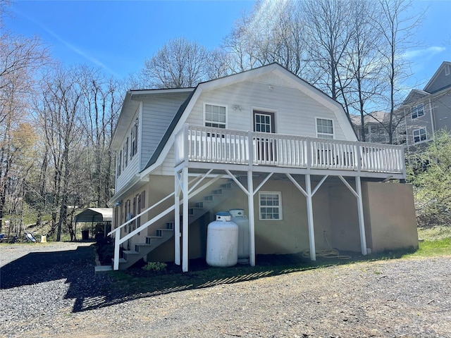 rear view of property featuring a deck