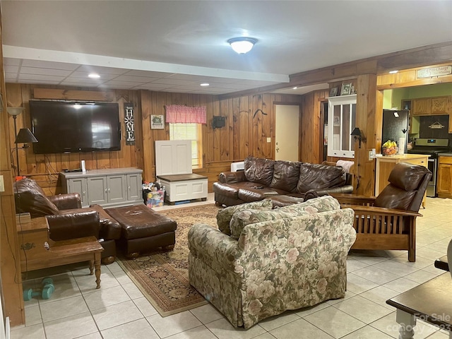 living room featuring wood walls and light tile flooring