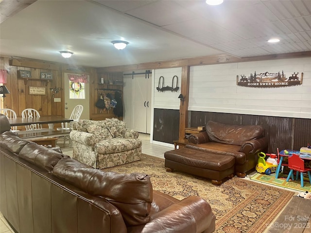 tiled living room with a barn door and wood walls