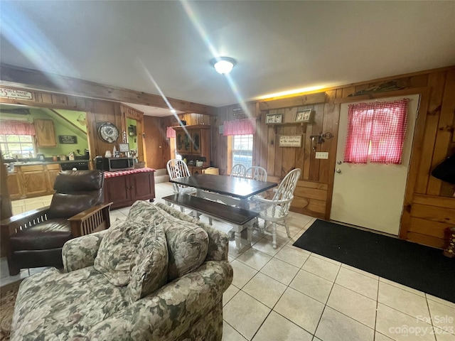 playroom featuring wooden walls and light tile flooring