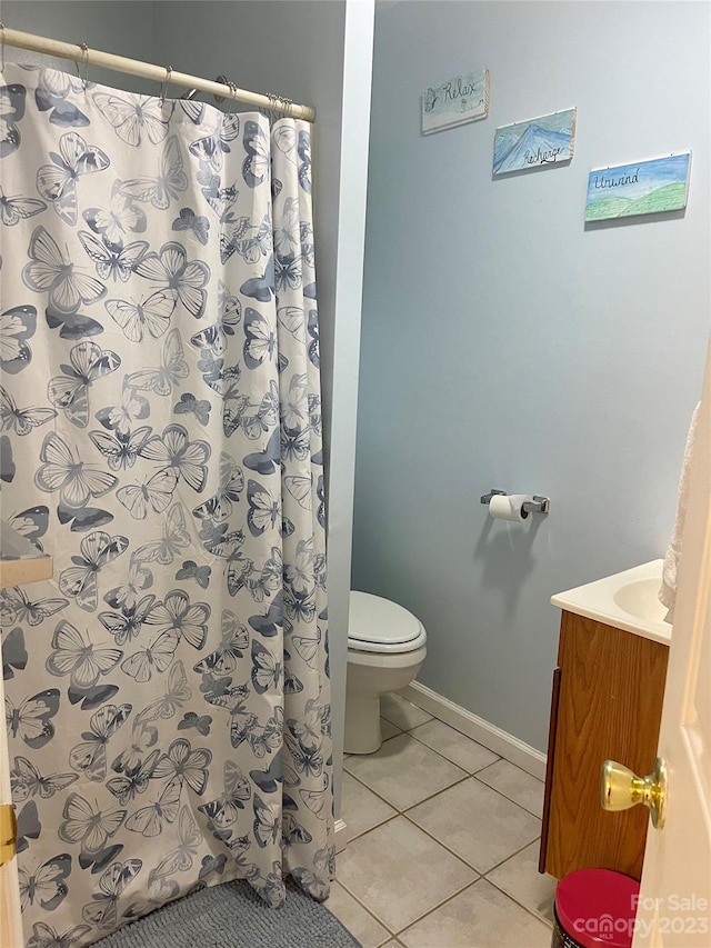 bathroom featuring tile floors, toilet, and vanity