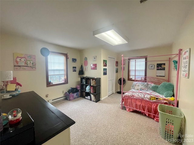 bedroom with baseboard heating and light colored carpet