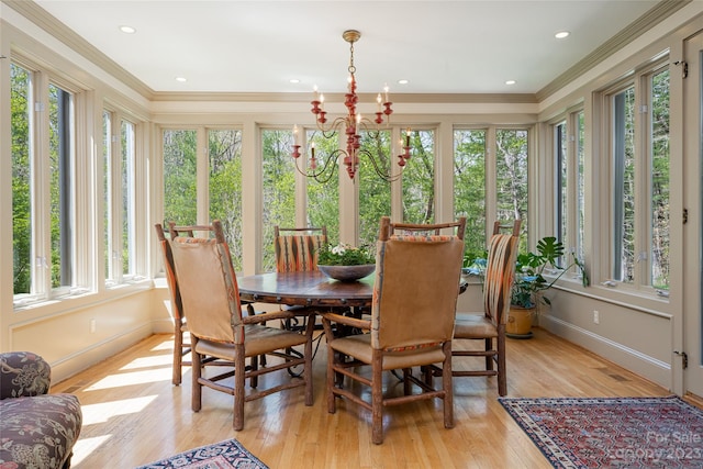 sunroom featuring a chandelier and plenty of natural light