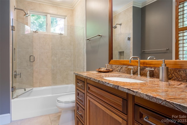 full bathroom with toilet, ornamental molding, large vanity, and tile flooring