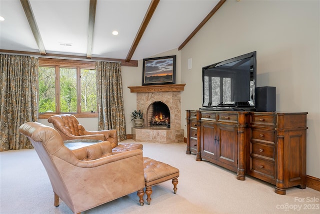 carpeted living room featuring vaulted ceiling with beams and a stone fireplace