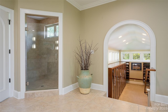 bathroom with an enclosed shower, tile floors, and ornamental molding