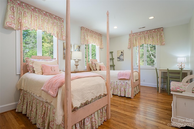 bedroom featuring multiple windows and light wood-type flooring