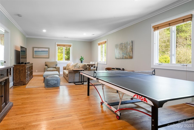 rec room featuring crown molding, light hardwood / wood-style flooring, and plenty of natural light