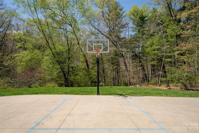 view of basketball court with a lawn