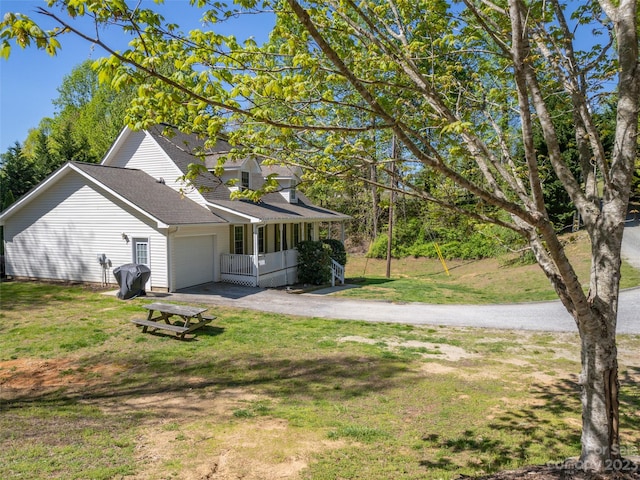 view of front of property with a front yard and a garage