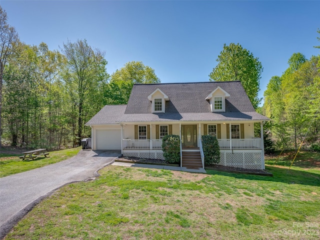 cape cod home featuring a front yard, a garage, and a porch