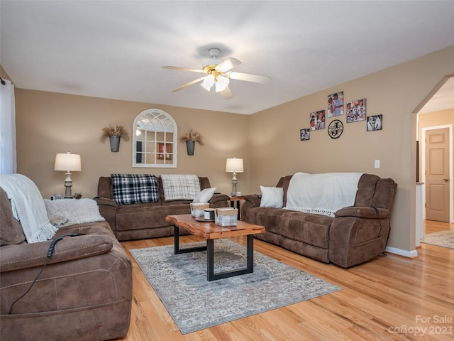 living room with light hardwood / wood-style floors and ceiling fan