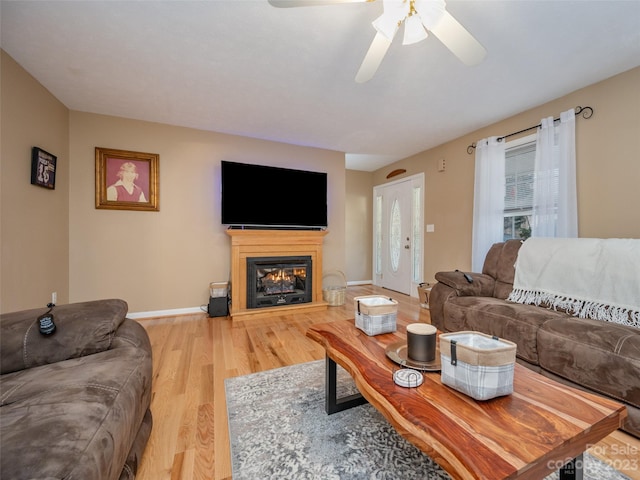 living room featuring hardwood / wood-style floors and ceiling fan