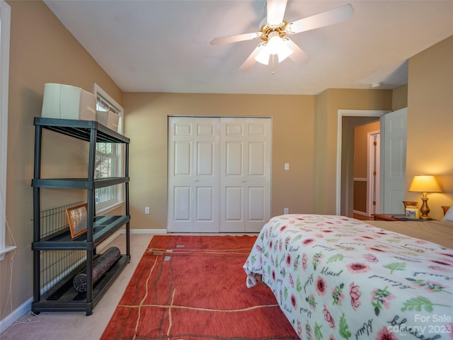 carpeted bedroom featuring a closet and ceiling fan