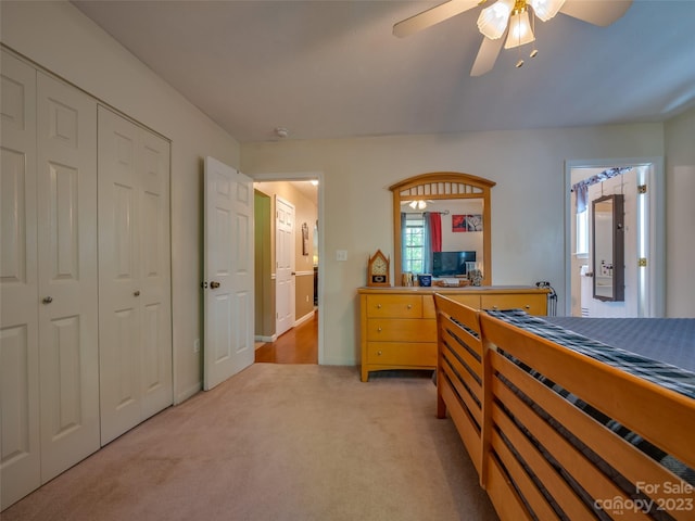 carpeted bedroom with a closet and ceiling fan