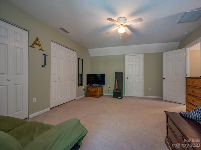 carpeted living room with lofted ceiling and ceiling fan